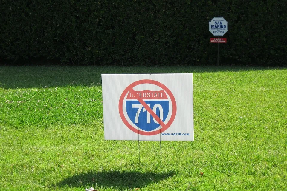 "No 710" lawn sign on green lawn.
